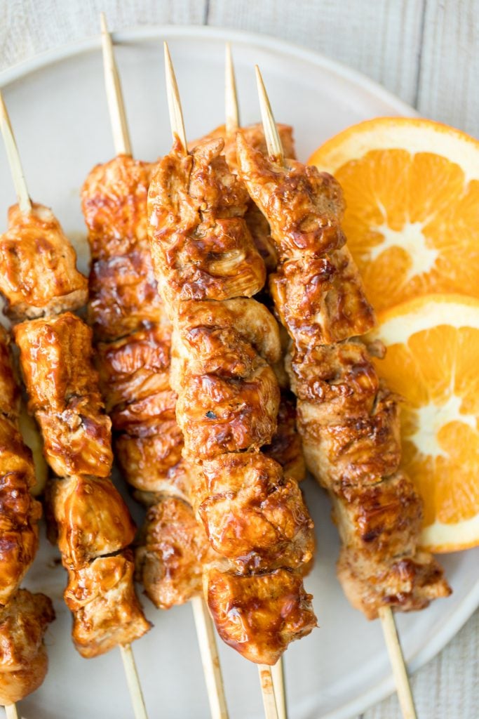 Flame-kissed, sticky and saucy, grilled orange chicken skewers with a rich, citrus-based marinade are delicious, juicy and so tender. Best weeknight dinner. | aheadofthyme.com