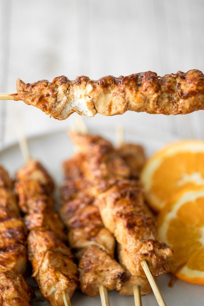 Flame-kissed, sticky and saucy, grilled orange chicken skewers with a rich, citrus-based marinade are delicious, juicy and so tender. Best weeknight dinner. | aheadofthyme.com