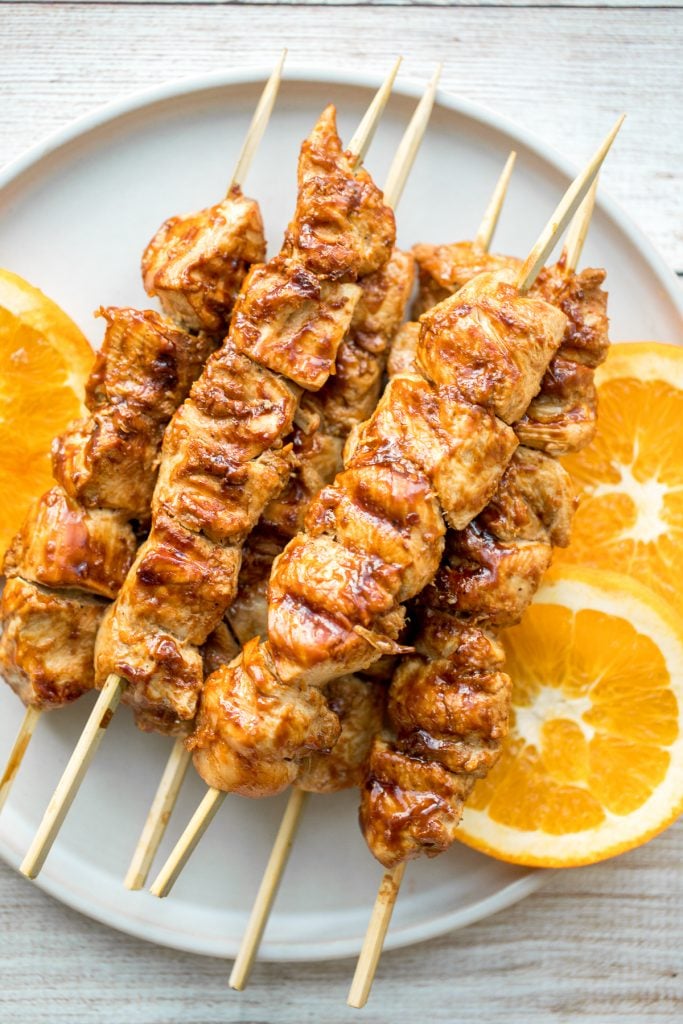 Flame-kissed, sticky and saucy, grilled orange chicken skewers with a rich, citrus-based marinade are delicious, juicy and so tender. Best weeknight dinner. | aheadofthyme.com