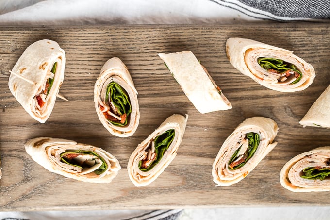 Turkey pinwheels are bite-sized finger food perfection and will make back-to-school lunch planning for the kids, entertaining guests at lunchtime, or serving appys at game day a total breeze! | aheadofthyme.com