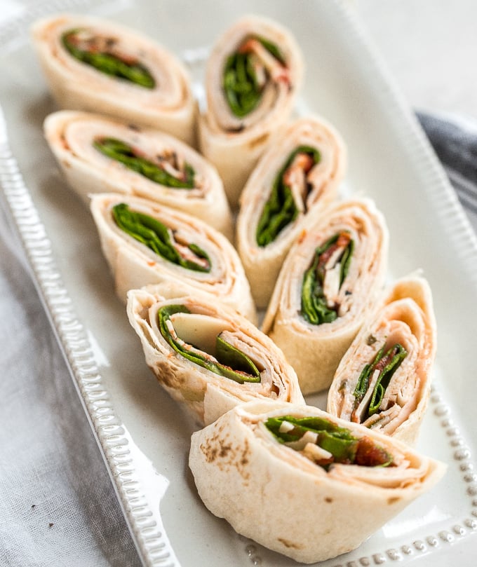 Turkey pinwheels are bite-sized finger food perfection and will make back-to-school lunch planning for the kids, entertaining guests at lunchtime, or serving appys at game day a total breeze! | aheadofthyme.com