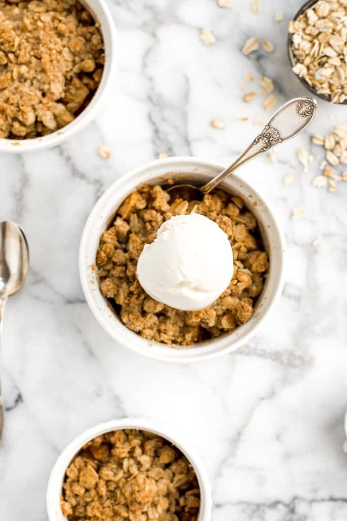 Individual apple crisp is a sweet tart fall dessert served in single-sized portions with all the crunchy corners of crumble. And so quick and easy to prep. | aheadofthyme.com