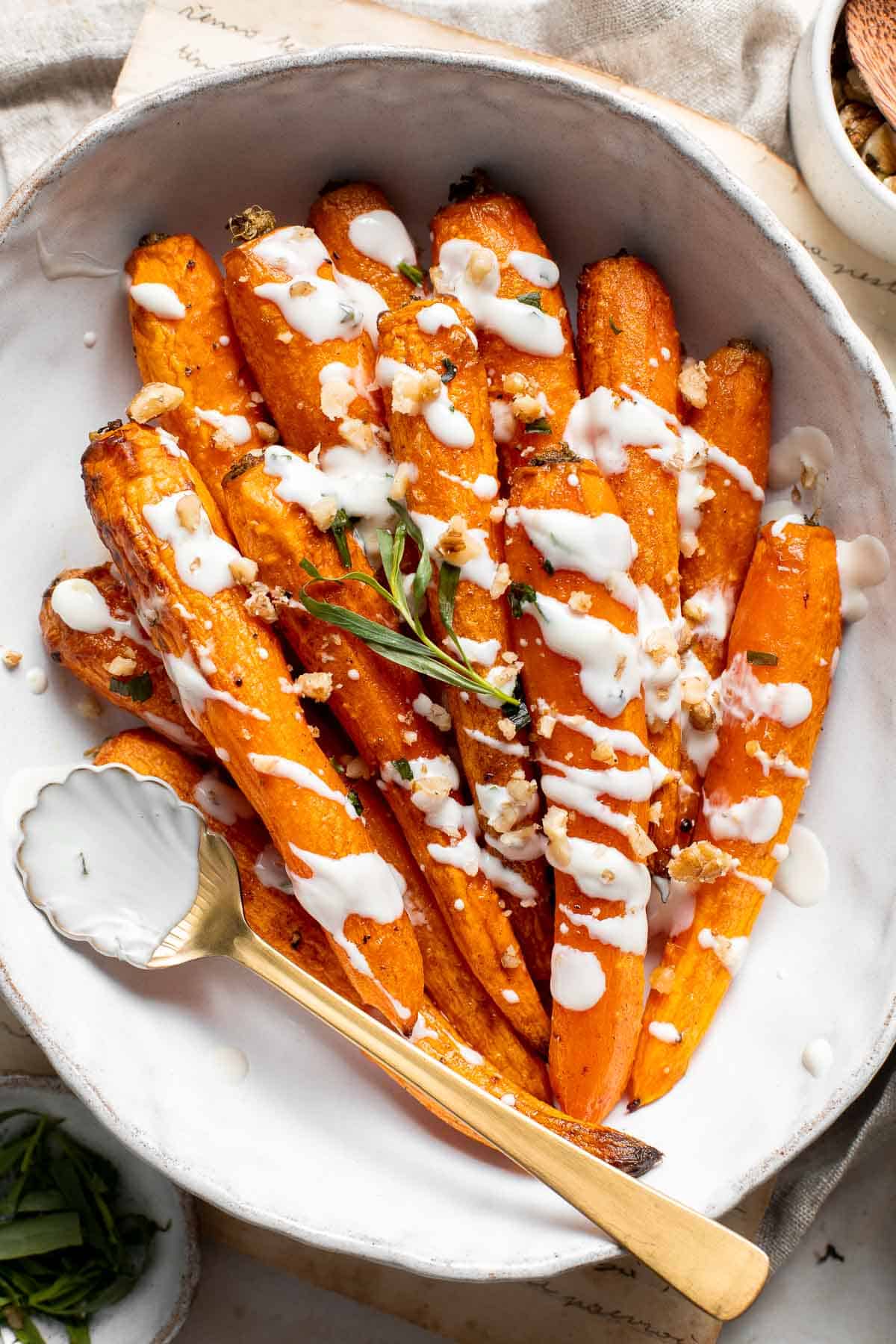 Maple Roasted Carrots with Yogurt Sauce is a quick, easy, flavorful, and delicious side dish that is warmly spiced and caramelized with maple syrup. | aheadofthyme.com