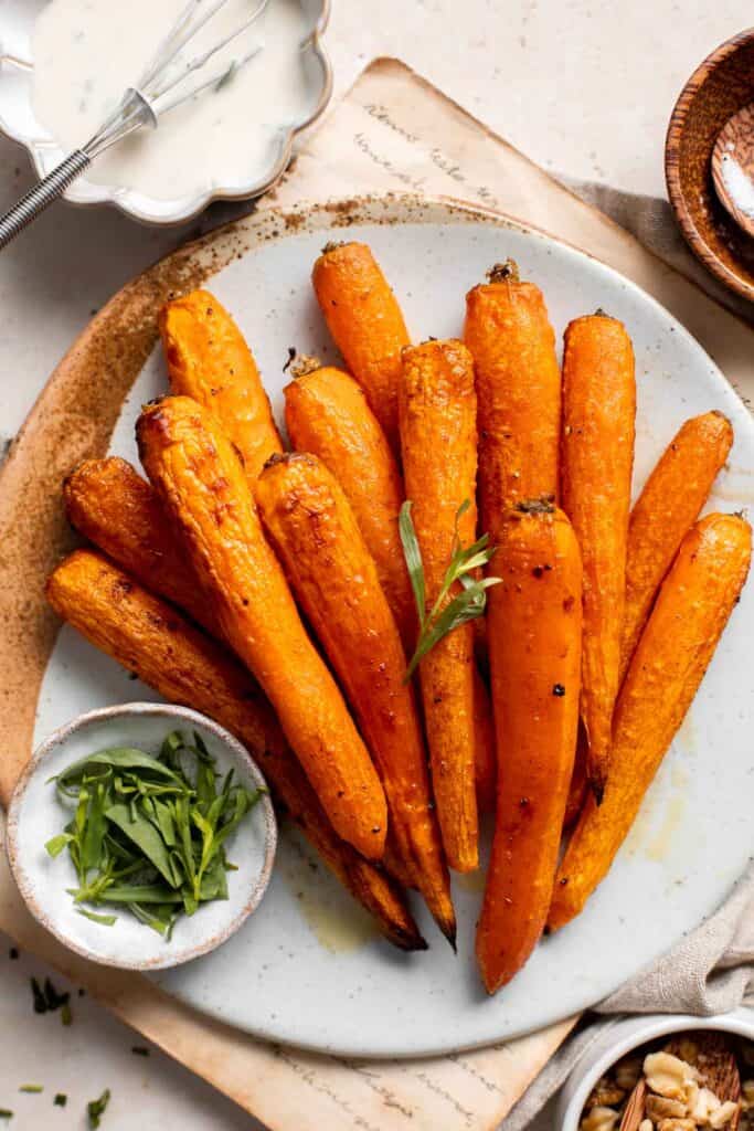 Maple Roasted Carrots with Yogurt Sauce is a quick, easy, flavorful, and delicious side dish that is warmly spiced and caramelized with maple syrup. | aheadofthyme.com