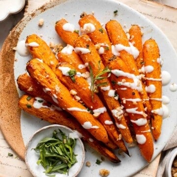 Maple Roasted Carrots with Yogurt Sauce is a quick, easy, flavorful, and delicious side dish that is warmly spiced and caramelized with maple syrup. | aheadofthyme.com