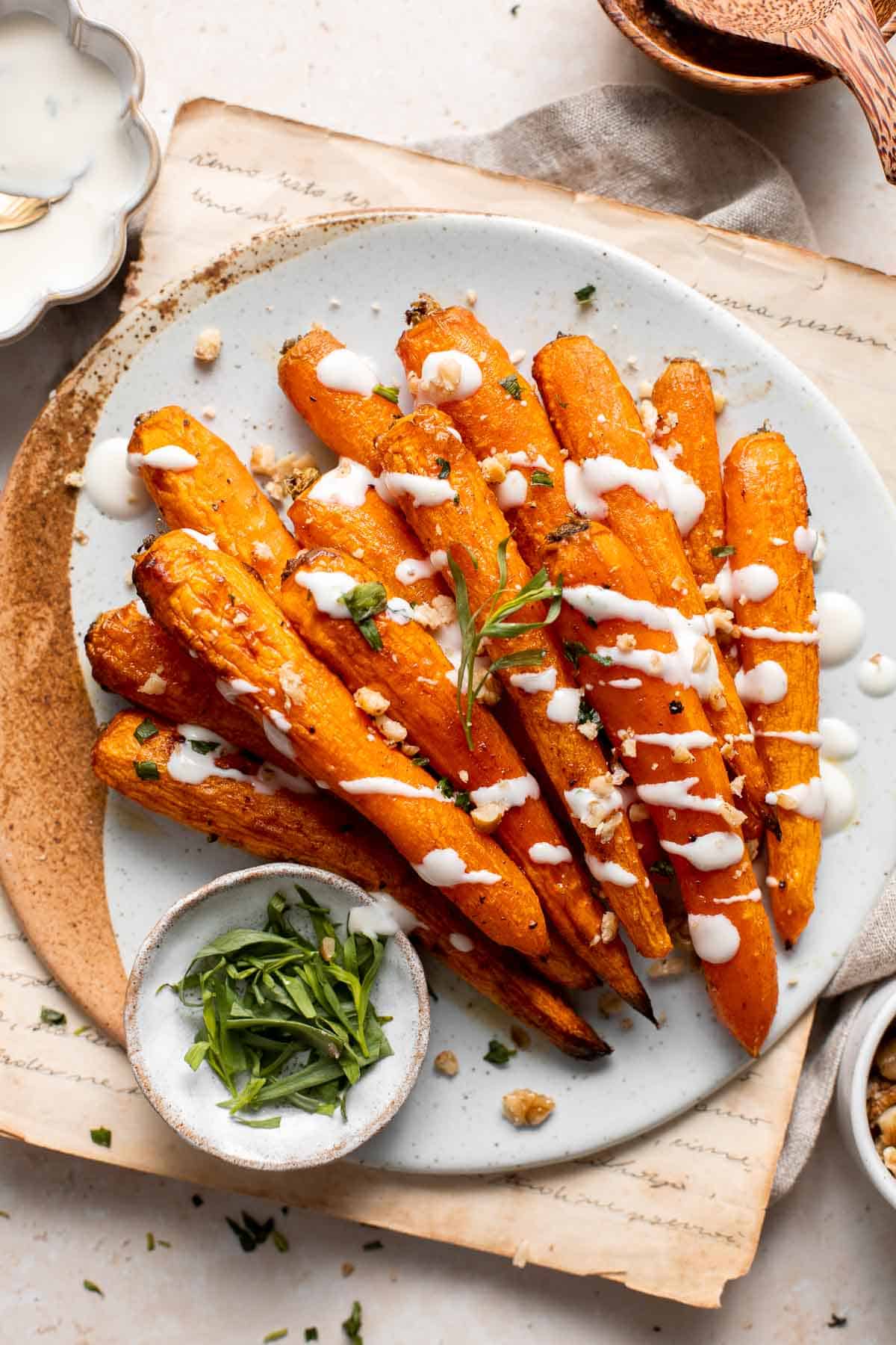 Maple Roasted Carrots with Yogurt Sauce is a quick, easy, flavorful, and delicious side dish that is warmly spiced and caramelized with maple syrup. | aheadofthyme.com