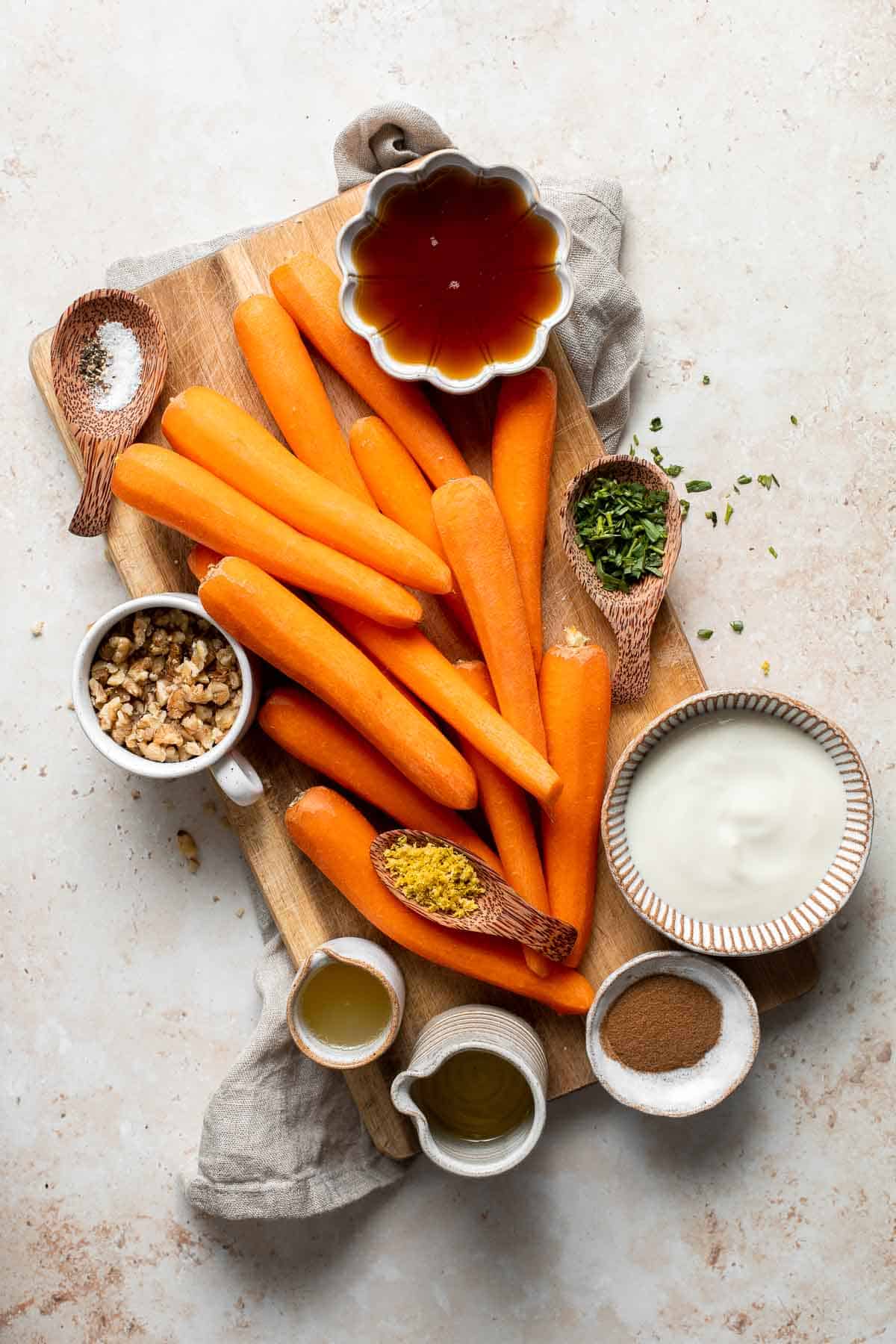 Maple Roasted Carrots with Yogurt Sauce is a quick, easy, flavorful, and delicious side dish that is warmly spiced and caramelized with maple syrup. | aheadofthyme.com