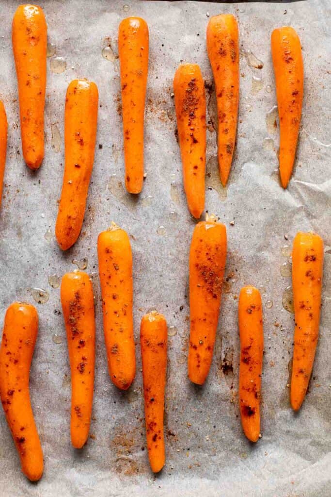 Maple Roasted Carrots with Yogurt Sauce is a quick, easy, flavorful, and delicious side dish that is warmly spiced and caramelized with maple syrup. | aheadofthyme.com