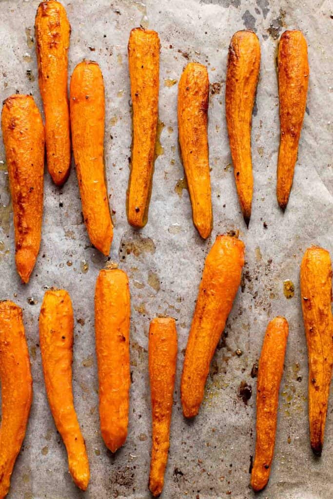 Maple Roasted Carrots with Yogurt Sauce is a quick, easy, flavorful, and delicious side dish that is warmly spiced and caramelized with maple syrup. | aheadofthyme.com