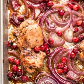 Roasted balsamic chicken with cranberries is a quick and easy 30-minute weeknight dinner made with tender chicken thighs in a sweet and tangy marinade. | aheadofthyme.com