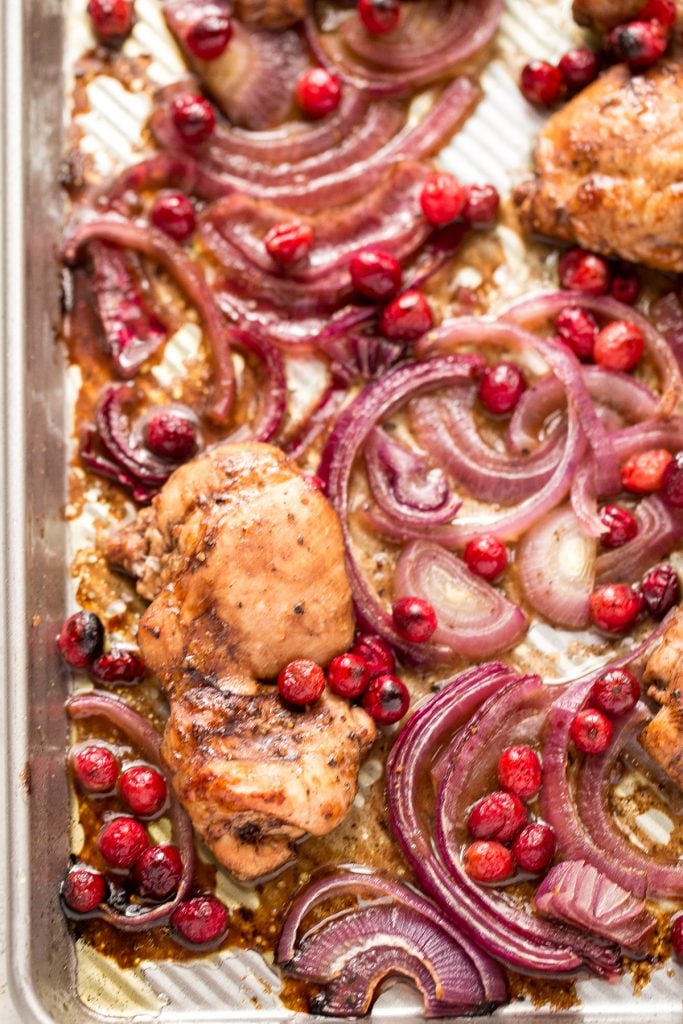 Roasted balsamic chicken with cranberries is a quick and easy 30-minute weeknight dinner made with tender chicken thighs in a sweet and tangy marinade. | aheadofthyme.com