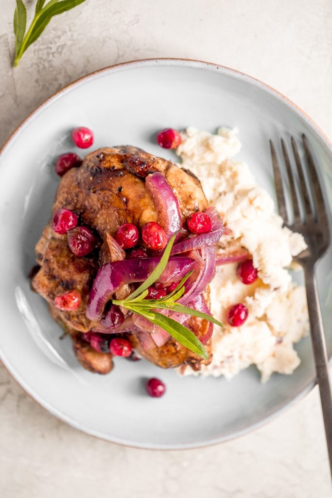 Roasted balsamic chicken with cranberries is a quick and easy 30-minute weeknight dinner made with tender chicken thighs in a sweet and tangy marinade. | aheadofthyme.com