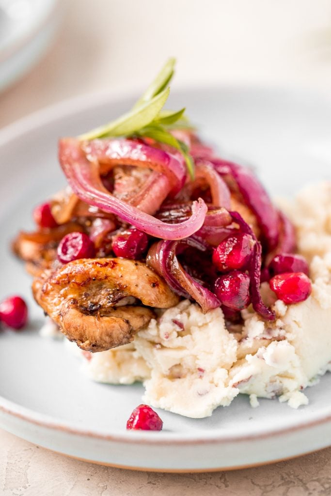 Roasted balsamic chicken with cranberries is a quick and easy 30-minute weeknight dinner made with tender chicken thighs in a sweet and tangy marinade. | aheadofthyme.com