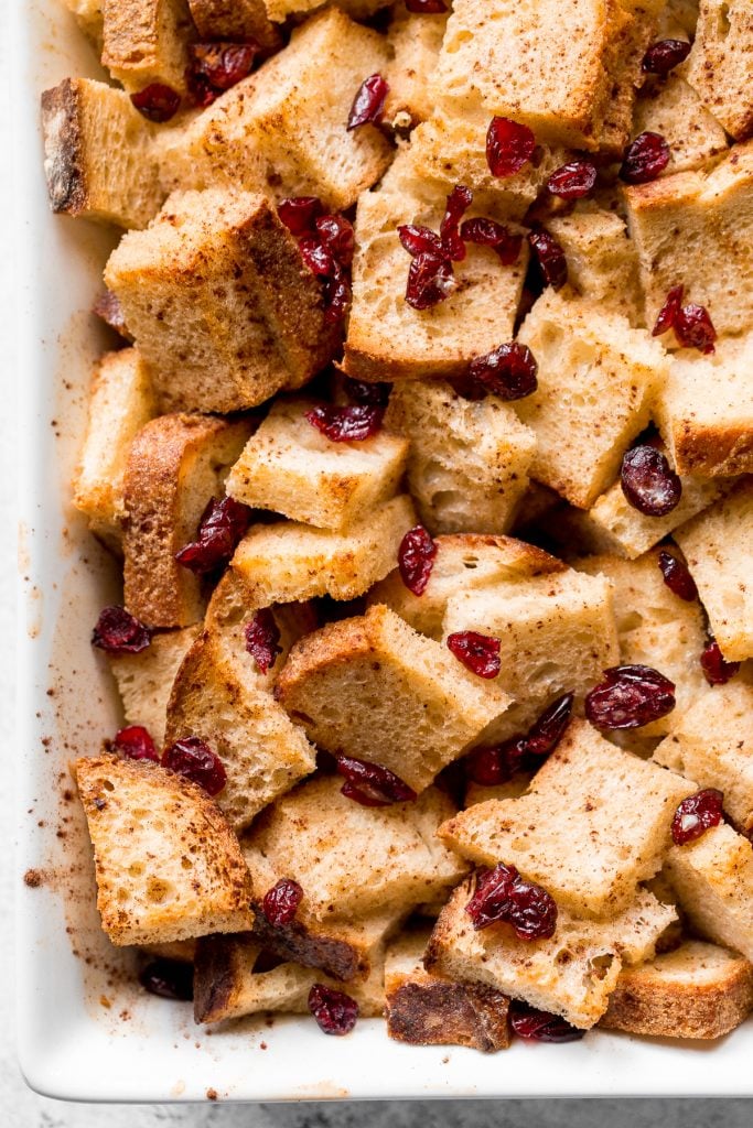 Festive baked gingerbread french toast casserole with cranberries is soft on the inside and crispy outside. The best holiday breakfast on Christmas morning. | aheadofthyme.com