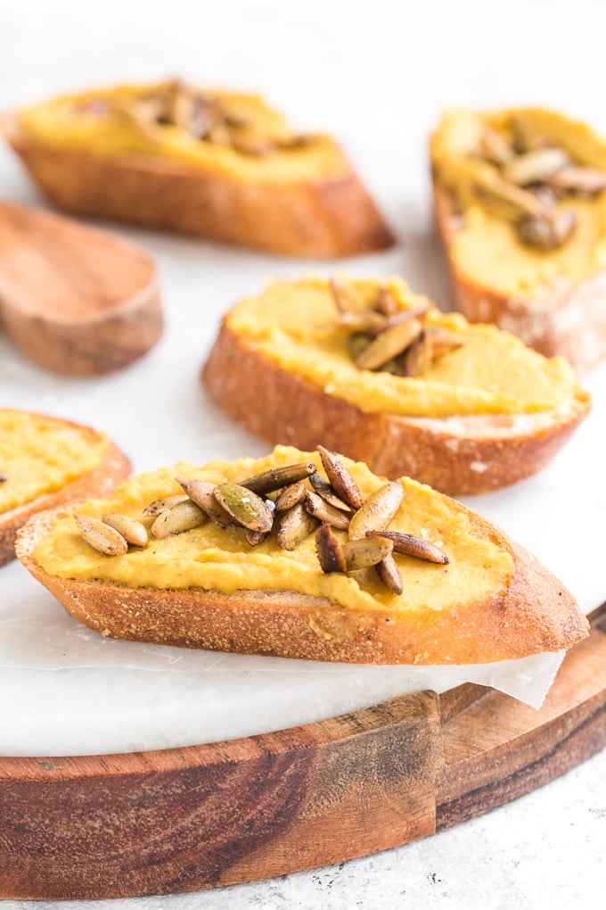 Curried white bean crostini with toasted pepitas is the perfect, sophisticated holiday appetizer that is ready to serve in under 15 minutes. | aheadofthyme.com