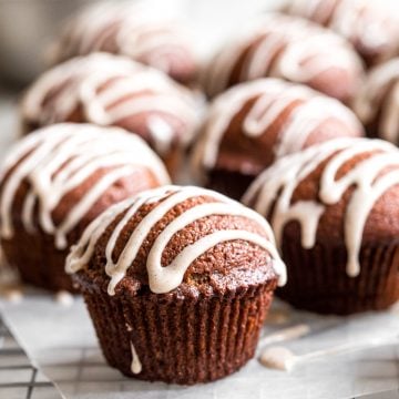 Festive gingerbread muffins with vanilla bean glaze are light, airy and fluffy with warm fragrant festive spices and rich molasses. A perfect holiday treat. | aheadofthyme.com