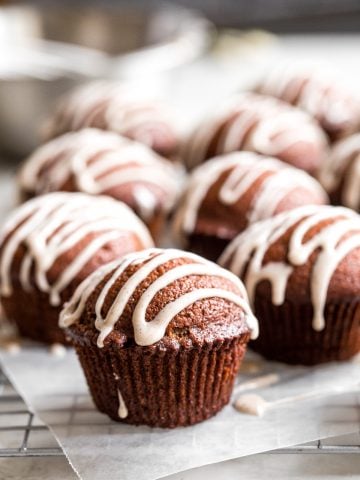 Festive gingerbread muffins with vanilla bean glaze are light, airy and fluffy with warm fragrant festive spices and rich molasses. A perfect holiday treat. | aheadofthyme.com