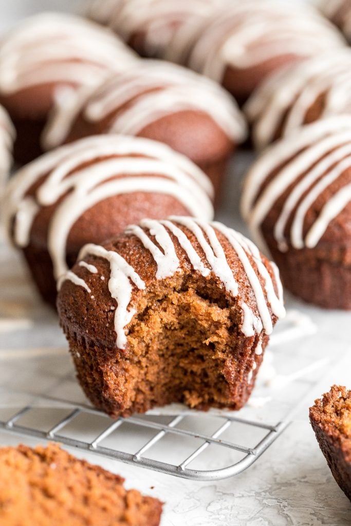 Festive gingerbread muffins with vanilla bean glaze are light, airy and fluffy with warm fragrant festive spices and rich molasses. A perfect holiday treat. | aheadofthyme.com