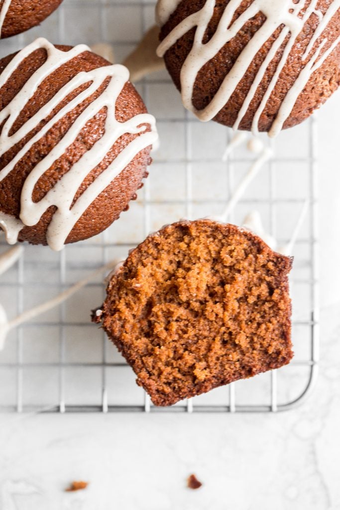 Festive gingerbread muffins with vanilla bean glaze are light, airy and fluffy with warm fragrant festive spices and rich molasses. A perfect holiday treat. | aheadofthyme.com