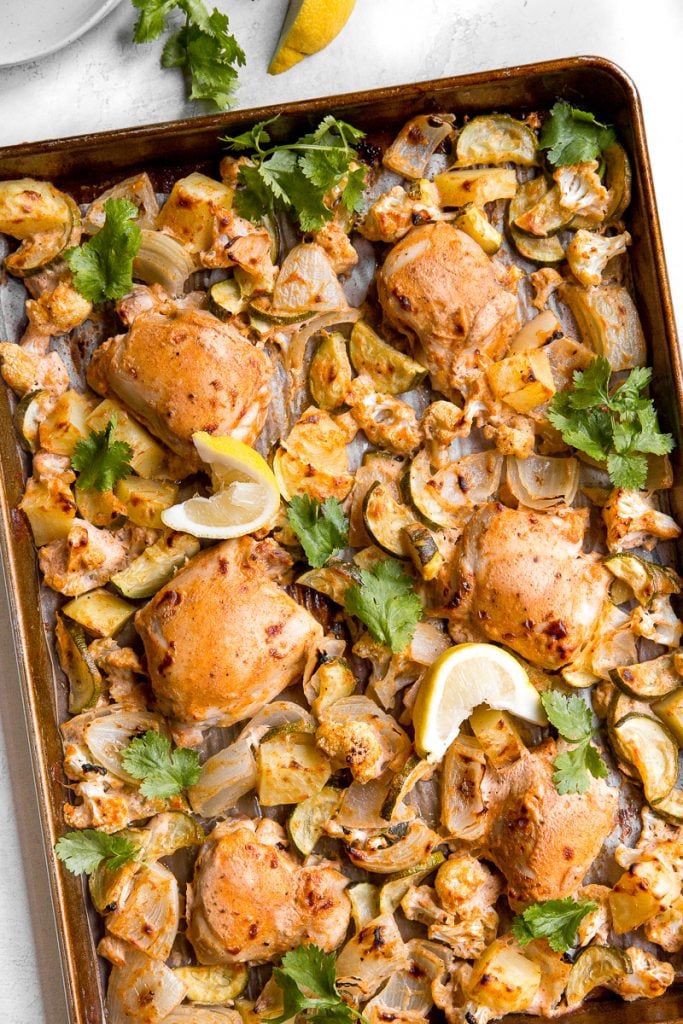 In under 30 minutes, create intensely flavourful tandoori chicken sheet pan dinner loaded with vegetables, any night of the week! Good-bye takeout! | aheadofthyme.com
