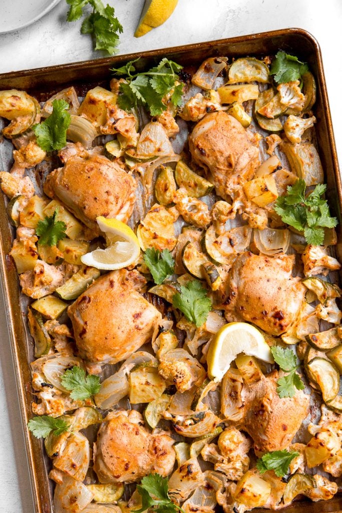 In under 30 minutes, create intensely flavourful tandoori chicken sheet pan dinner loaded with vegetables, any night of the week! Good-bye takeout! | aheadofthyme.com