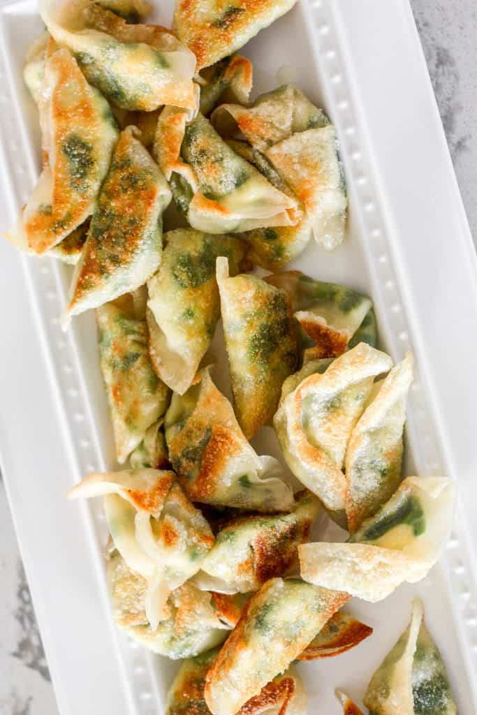 Fragrant chives with fluffy scrambled eggs, and a dash of flavour come together to create the perfect appetizer -- egg and chive vegetarian dumplings. | aheadofthyme.com