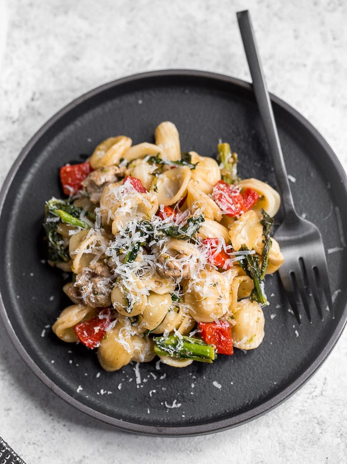 Orecchiette pasta with sausage, broccoli rabe, and roasted red peppers is a mix of spicy, sweet, and crunchy, and is on the table in less than 30 minutes! | aheadofthyme.com