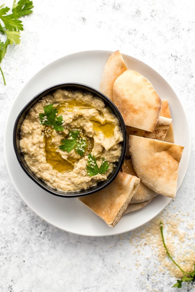 Baba ganoush is a creamy, roasted eggplant dip mixed with garlic and tahini for an explosion of flavor! It is perfect served with pita chips or veggies. | aheadofthyme.com