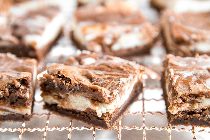 Caramel cheesecake brownies are totally indulgent and worth the effort, so toss that prepared brownie mix away and bake this with a few easy ingredients! | aheadofthyme.com