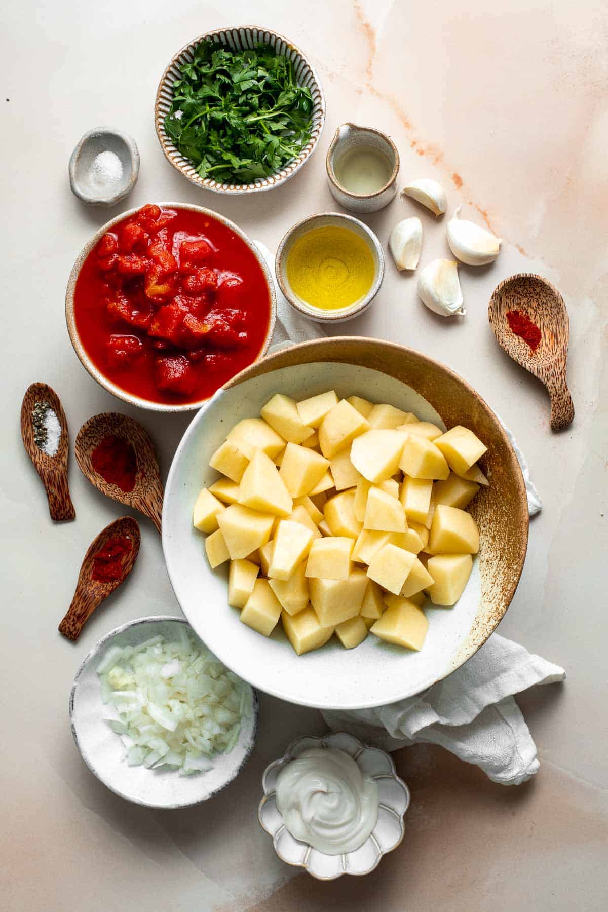 Skip the tapas bar and make Patatas Bravas at home with crispy, roasted potatoes smothered in a homemade sweet and spicy tomato sauce and garlic aioli. | aheadofthyme.com