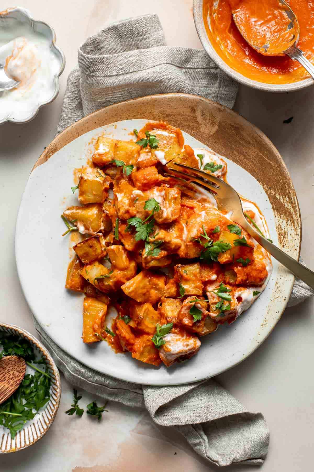 Skip the tapas bar and make Patatas Bravas at home with crispy, roasted potatoes smothered in a homemade sweet and spicy tomato sauce and garlic aioli. | aheadofthyme.com