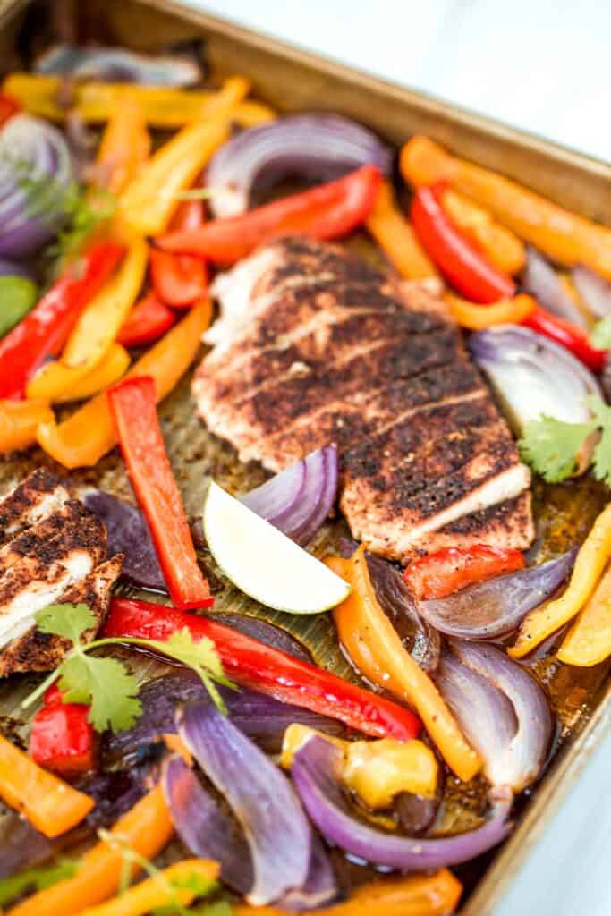 Sheet pan chicken fajitas are quick and easy to make, loaded with flavor, delicious, and ready in less than 30 minutes. Great for meal prep too. | aheadofthyme.com