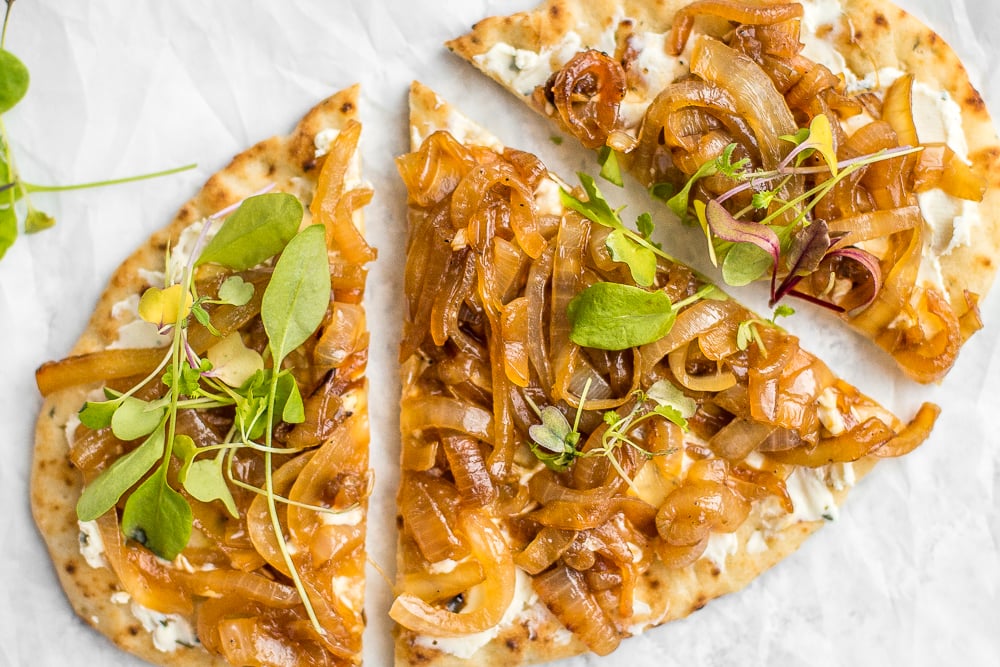 Crispy flatbread, warm, melty goat cheese with garlic and herbs, and mounds of sweet onion. You seriously cannot go wrong with caramelized onion and herbed goat cheese flatbread. | aheadofthyme.com