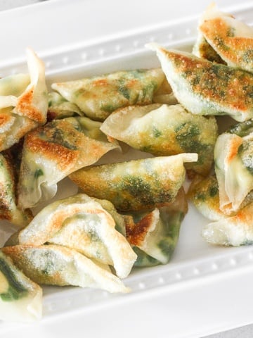 Fragrant chives with fluffy scrambled eggs, and a dash of flavour come together to create the perfect appetizer -- egg and chive vegetarian dumplings. | aheadofthyme.com