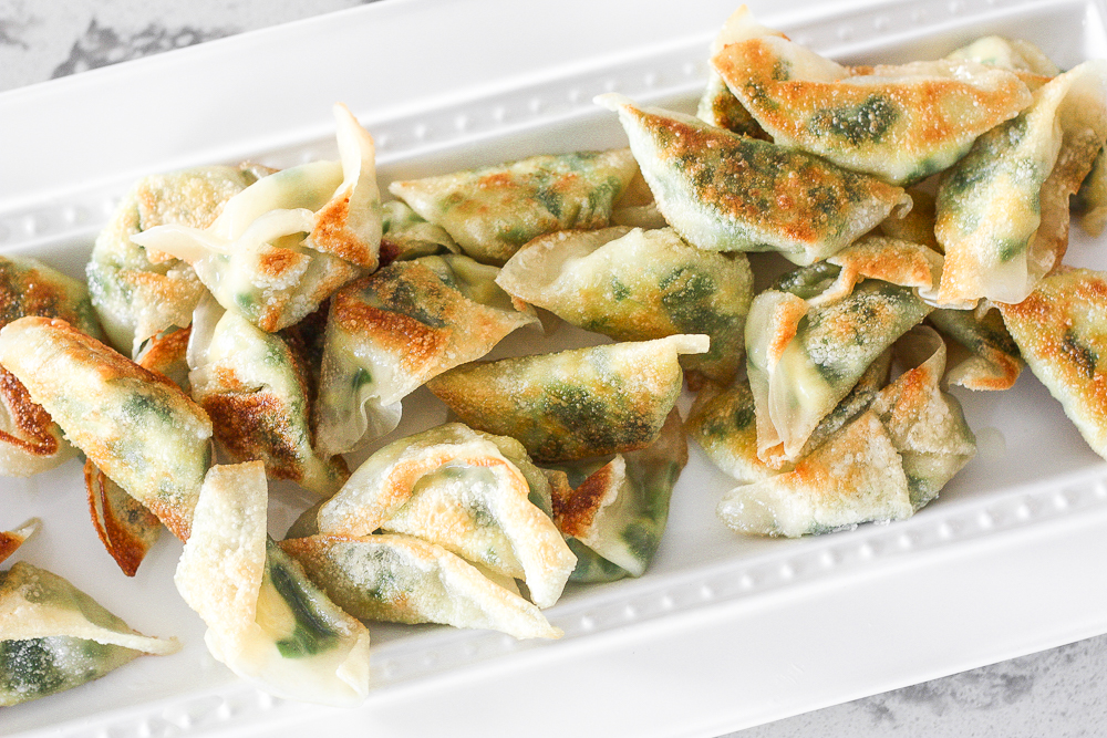 Fragrant chives with fluffy scrambled eggs, and a dash of flavour come together to create the perfect appetizer -- egg and chive vegetarian dumplings. | aheadofthyme.com