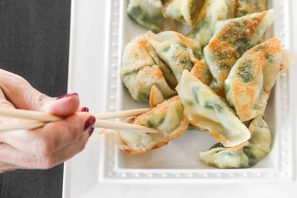 Fragrant chives with fluffy scrambled eggs, and a dash of flavour come together to create the perfect appetizer -- egg and chive vegetarian dumplings. | aheadofthyme.com