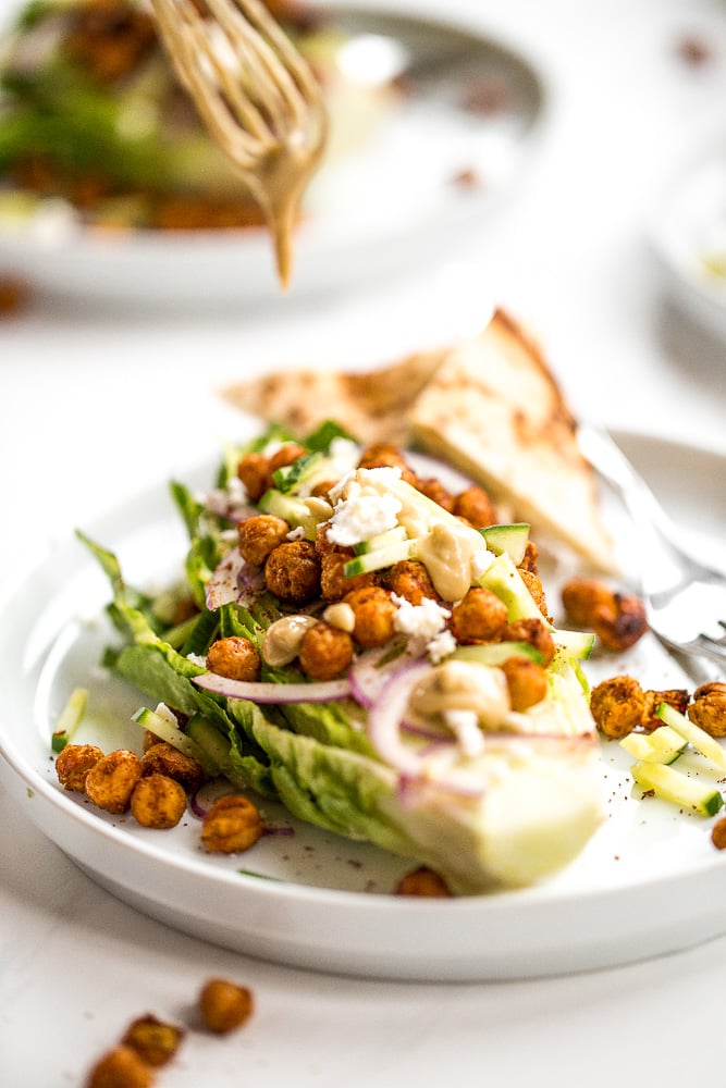 Mediterranean chickpea wedge salad combines chickpeas, crunchy vegetable toppings, and hummus dressing for a delicious deconstructed falafel flavour. | aheadofthyme.com