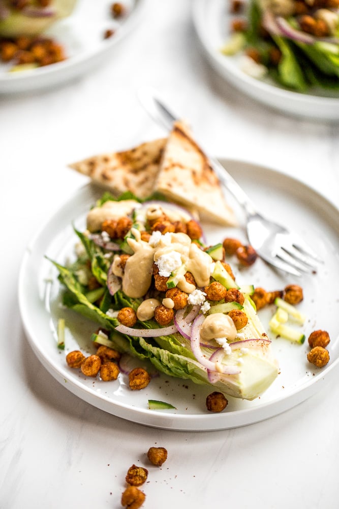 Mediterranean chickpea wedge salad combines chickpeas, crunchy vegetable toppings, and hummus dressing for a delicious deconstructed falafel flavour. | aheadofthyme.com