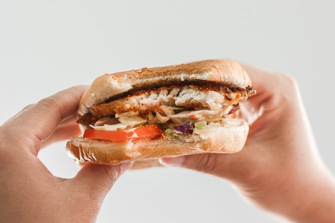 This 15-minute fish burgers with creamy slaw is juicy, flakey, and packed with flavour. So easy that it's the perfect summer weeknight meal! | aheadofthyme.com