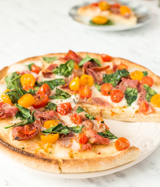 The combination of salty prosciutto, sweet tomatoes, gooey mozzarella and delicate spinach to come together to create a masterpiece -- spinach tomato and prosciutto pizza! | aheadofthyme.com