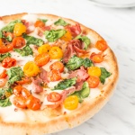 The combination of salty prosciutto, sweet tomatoes, gooey mozzarella and delicate spinach to come together to create a masterpiece -- spinach tomato and prosciutto pizza! | aheadofthyme.com