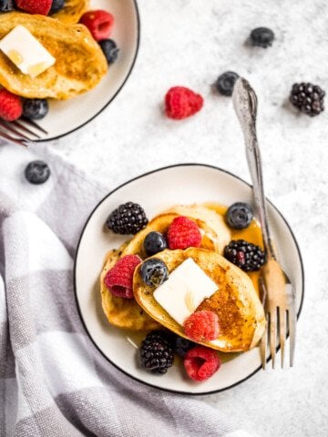 Triple berry french toast with warm slices of bread, creamy egg mixture, an overload of berries, and maple syrup drizzled on top is breakfast goals. | aheadofthyme.com