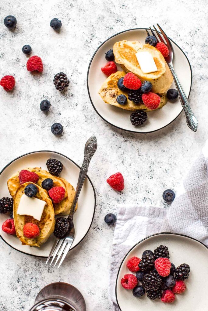 Triple berry french toast with warm slices of bread, creamy egg mixture, an overload of berries, and maple syrup drizzled on top is breakfast goals. | aheadofthyme.com