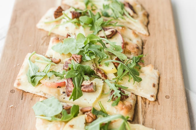 Crisp apples, peppery arugula, crunchy pecans and warm, melty aged cheddar cheese ... you seriously cannot go wrong with apple and arugula flatbread. | aheadofthyme.com