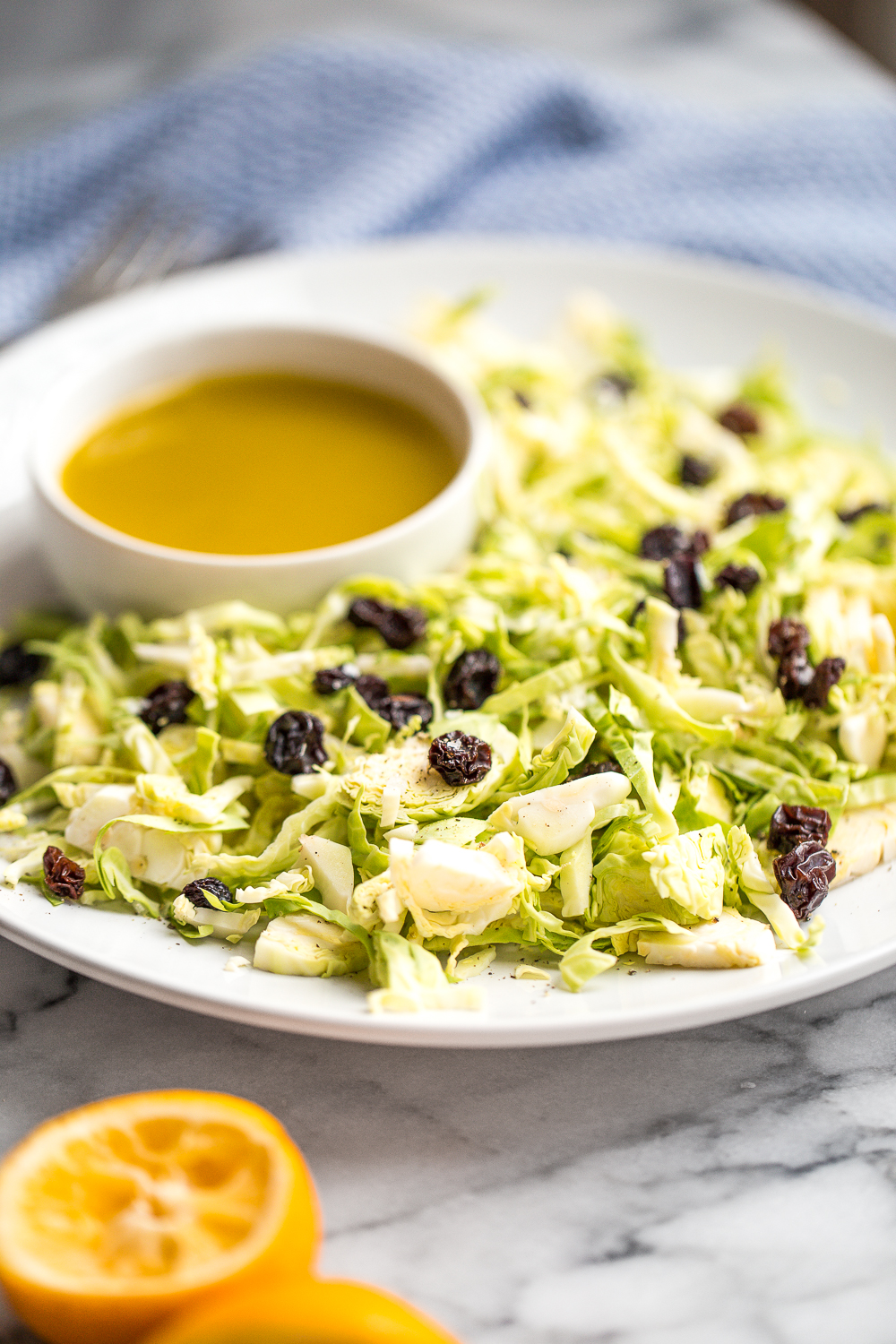 Brussels sprouts salad with warm lemon anchovy vinaigrette is pungent, but in the best possible way! A total explosion of flavours and perfect for a light, filling meal! | aheadofthyme.com