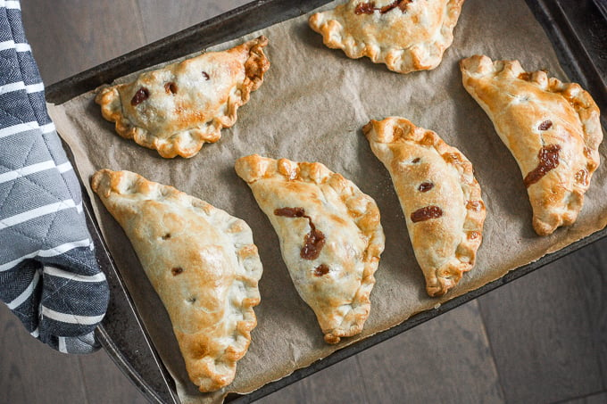 Easy homemade apple hand pies are the perfect fall treat -- stuffed with tender apples and cinnamon and wrapped in crispy, flakey, buttery crust. | aheadofthyme.com