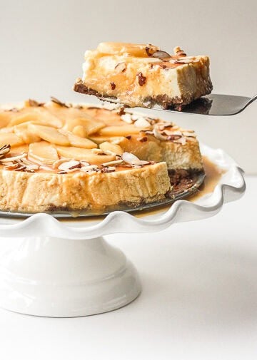 Decadent and light, homemade healthier caramel apple fall cheesecake is made with a graham cracker crust, topped with caramel apples and caramel sauce. It's fall heaven. | aheadofthyme.com