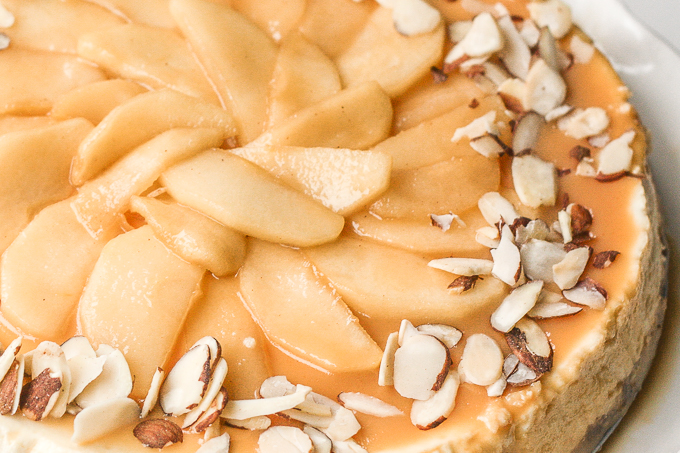 Decadent and light, homemade healthier caramel apple fall cheesecake is made with a graham cracker crust, topped with caramel apples and caramel sauce. It's fall heaven. | aheadofthyme.com