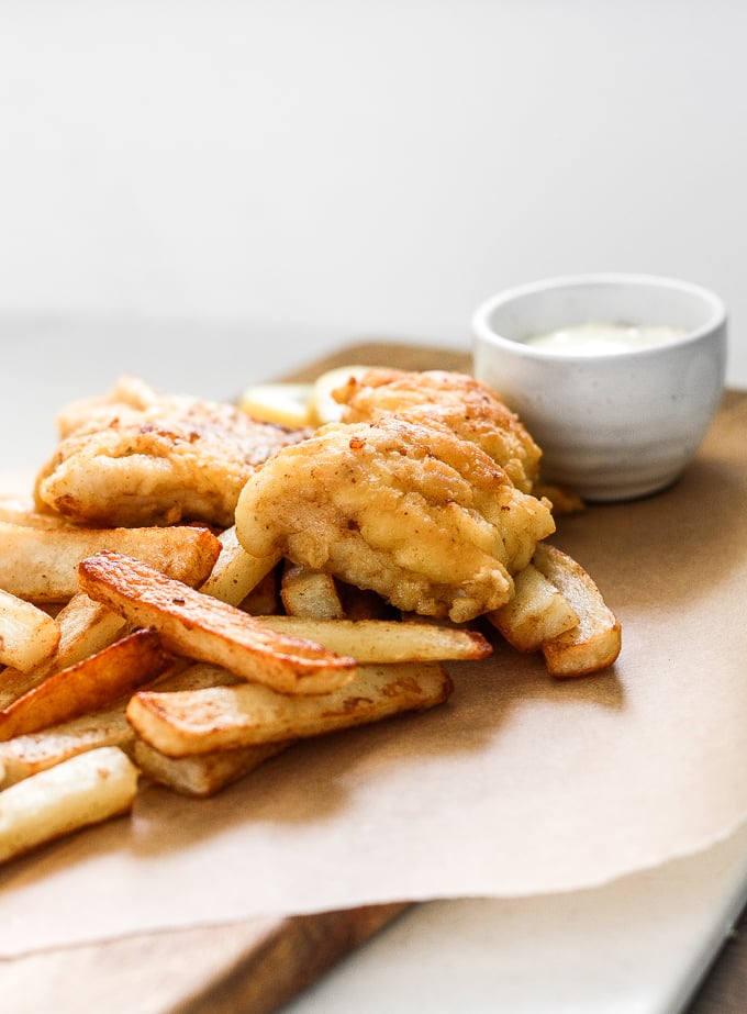 These healthy fish and chips are crispy on the outside and juicy, tender, and flakey on the inside. Pair it with homemade tartar sauce and say hello to comfort food heaven! | aheadofthyme.com
