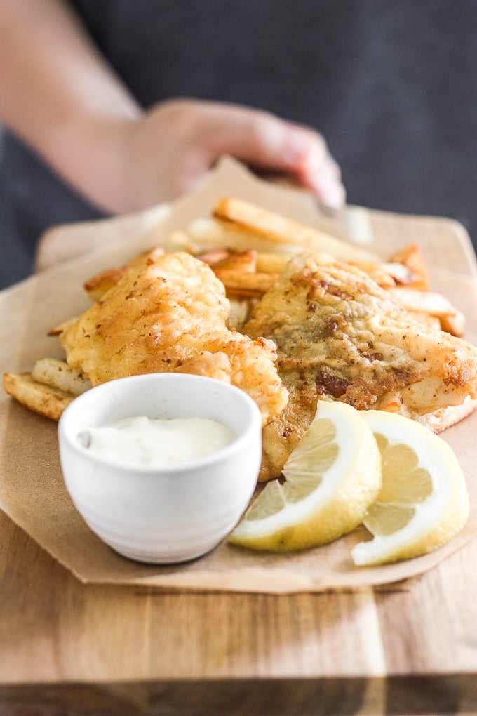 These healthy fish and chips are crispy on the outside and juicy, tender, and flakey on the inside. Pair it with homemade tartar sauce and say hello to comfort food heaven! | aheadofthyme.com